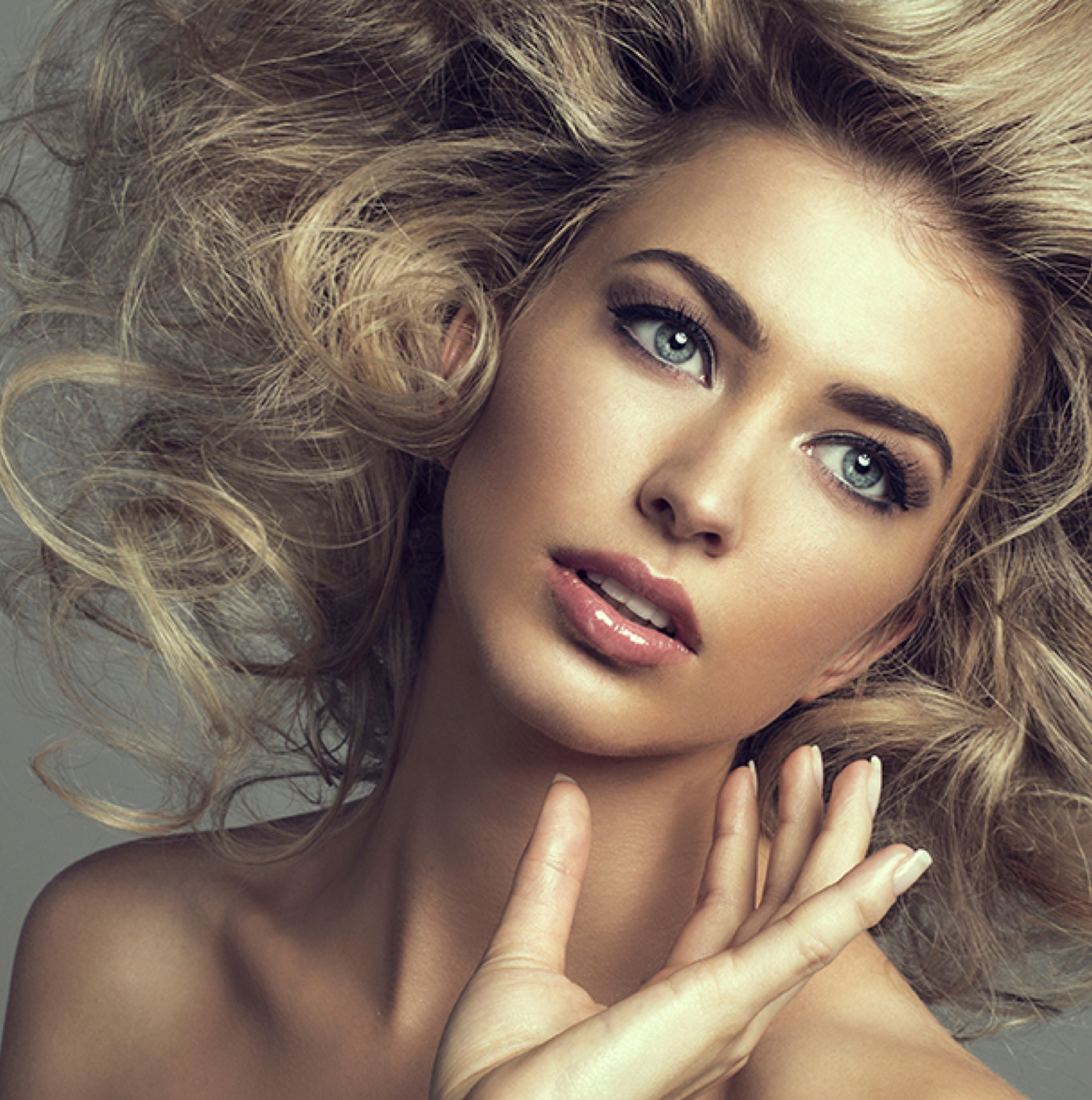 close up on model's face with smooth perfect skin and symmetrical facial features.